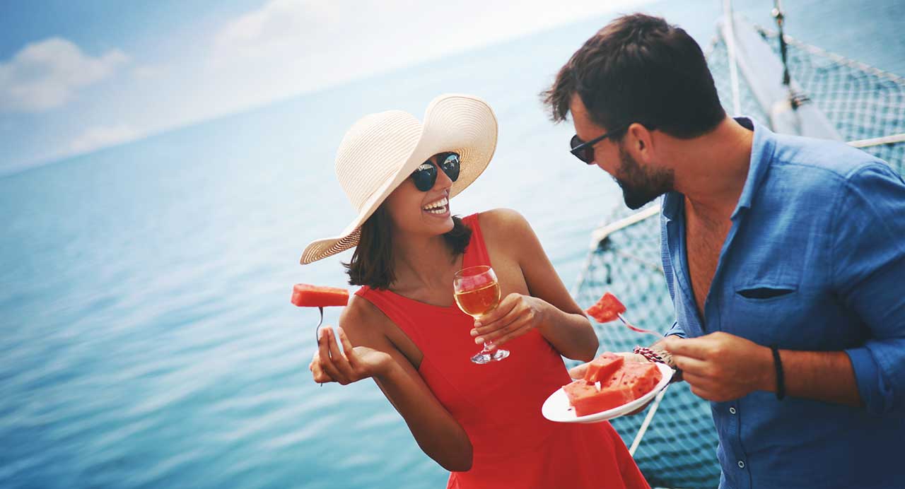 couple drinking and eating watermelon on a boat in the sarasota bay