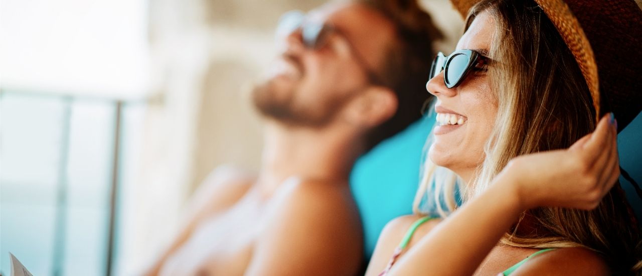 couple lounging poolside at bayso sarasota