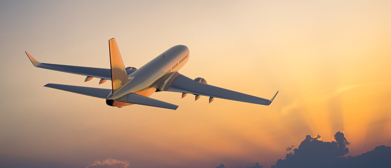 plane flying with orange skies to sarasota international airport